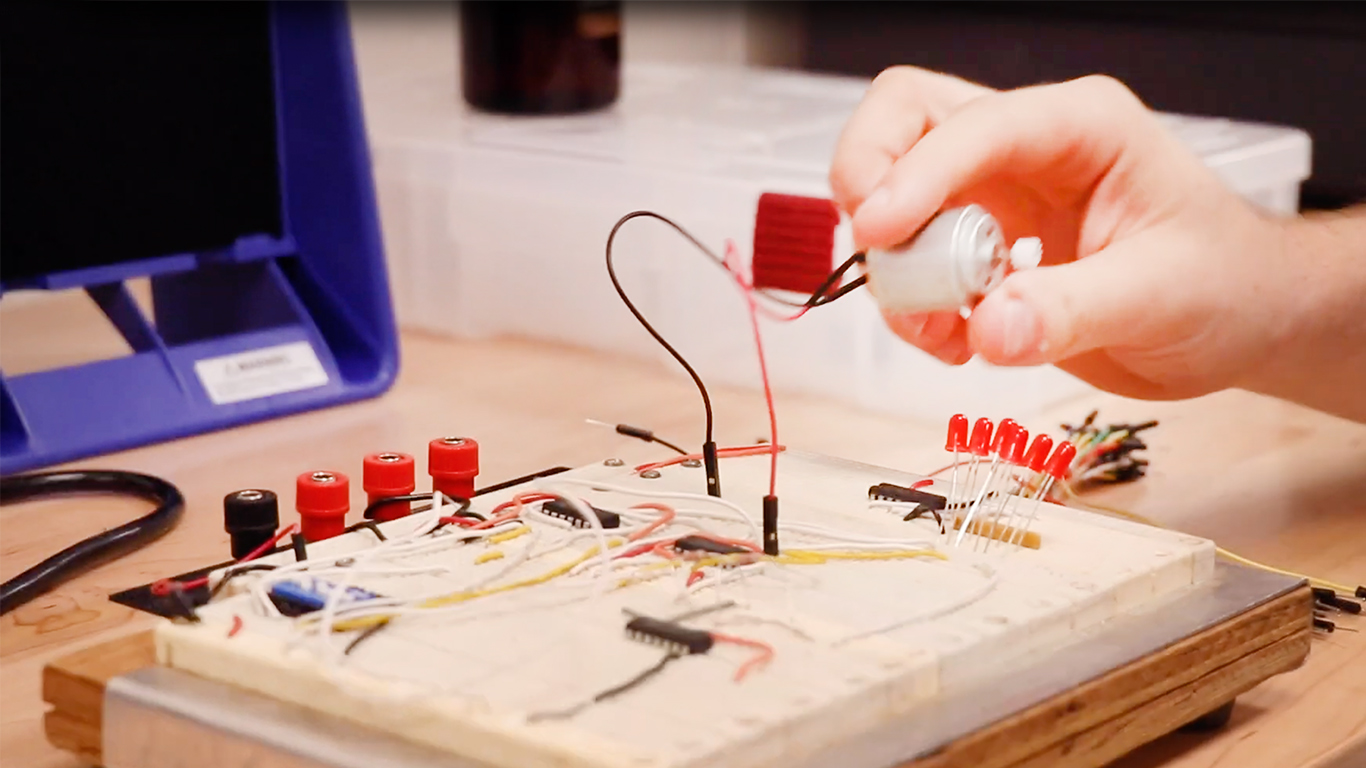 Photo of a hand holding electronics in the Maker Studio