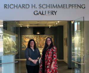 Rebecca Parmer and Anne Langley in front of the Richard H. Schimmelpfeng Gallery