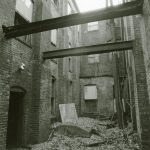 black and white image of rubber remnants surrounded by vacant buildings and a tree from the Hartford Rubber Works, Hartford CT