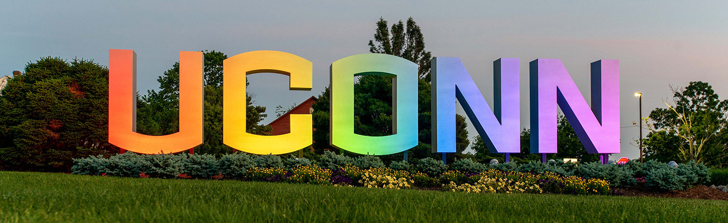 The UConn Sign along Route 195 in Storrs, CT. Illuminated with rainbow lighting.