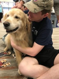 student hugging dog