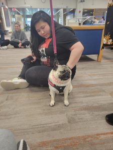 student petting a dog